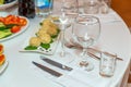 Served for holiday banquet restaurant table with dishes, snack, cutlery, wine and water glasses Royalty Free Stock Photo