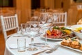 Served for holiday banquet restaurant table with dishes, snack, cutlery, wine and water glasses Royalty Free Stock Photo