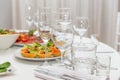 Served for holiday banquet restaurant table with dishes, snack, cutlery, wine and water glasses Royalty Free Stock Photo