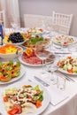 Served for holiday banquet restaurant table with dishes, snack, cutlery, wine and water glasses Royalty Free Stock Photo