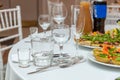 Served for holiday banquet restaurant table with dishes, snack, cutlery, wine and water glasses Royalty Free Stock Photo