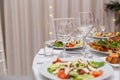 Served for holiday banquet restaurant table with dishes, snack, cutlery, wine and water glasses Royalty Free Stock Photo