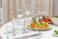Served for holiday banquet restaurant table with dishes, snack, cutlery, wine and water glasses Royalty Free Stock Photo