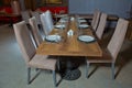 Set of a dish with spoon, fork and knife on wooden table. Empty Table setting on woo den table in restaurant served for dinner . Royalty Free Stock Photo