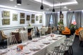 Served long table in modern urban restaurant. Panoramic view of room of luxury restaurant or cafe interior