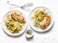 Served lunch - dijon baked chicken with rice, courgettes and fried onions on light background