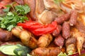 Served meat plate with grilled sausages and vegetables sliced Royalty Free Stock Photo