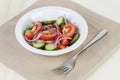 Served plate with mix salad from tomatoes and cucumbers