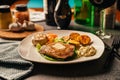 Served plate of seared tenderloin steak with side of baked baby potatoes and garlic dip.Filet mignon dinner for special occasion