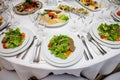 Served round banquet table with dishes Royalty Free Stock Photo