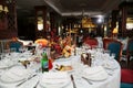 served round table for festive banquet. flowers, glasses, tableware and snacks.