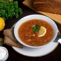 Served soup with a slice of lemon and bread