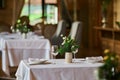 served table with burning candles and fresh flowers for a festive dinner. Royalty Free Stock Photo