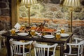 Served table with different dishes in the restaurant. Old restaurant interior with set table. Royalty Free Stock Photo
