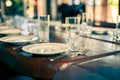 Served table with empty plates, glass goblets and, forks, knives. cutlery in the restaurant