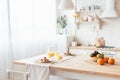 Served table with pancakes, fruits and orange juice in kitchen. Royalty Free Stock Photo