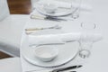 Served table in the restaurant. clean white dishes layout on a white tablecloth Royalty Free Stock Photo