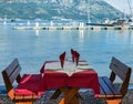 Served table on sea beach restaurant of Budva, Montenegro Royalty Free Stock Photo