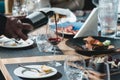 Sommelier at wine tasting pouring wine from a bottle into glass at wine tasting Royalty Free Stock Photo