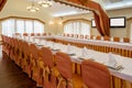 Served tables arranged in banquet hall prepared for festive celebration Royalty Free Stock Photo