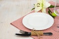 Served wooden restaurant table with settings on red checkered tablecloth