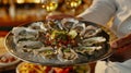 A server bringing out a tray of freshly shucked oysters with a variety of accompaniments