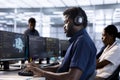Server farm IT specialist listening music while doing AI research Royalty Free Stock Photo