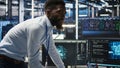 Server farm supervisor and man with disability oversee AI analytics Royalty Free Stock Photo