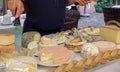 Server points out various Cheeses on Platter in France Restaurant