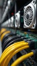 Server rack with active cooling fans and yellow data cables connected to network hardware. Digital infrastructure components Royalty Free Stock Photo