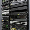 A server rack filled with various network devices and routers. Each device has multiple Royalty Free Stock Photo