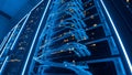 Server Racks with Blue Neon Lights and Network Cables in Data Center, Futuristic Technology Concept Royalty Free Stock Photo