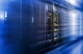 Server racks row in big data center with depth of field in cool blue tone and motion effect Royalty Free Stock Photo