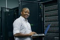 Server room, black man or portrait of technician with laptop for online cyber security glitch or software. IT support Royalty Free Stock Photo