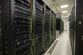 Server room filled with network racks and equipment in a modern data center during the day Royalty Free Stock Photo