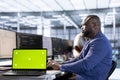 Server room programmer using green screen laptop Royalty Free Stock Photo