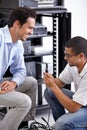 Server room, it support and cables with a technician talking to a business man about service or maintenance. Network Royalty Free Stock Photo