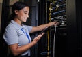 Server room, tablet and engineer woman with connection cable for maintenance or software update at night. Cybersecurity Royalty Free Stock Photo