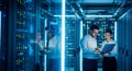 Server Room Technicians Working on Laptop in Data Center Royalty Free Stock Photo