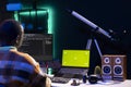 Server technician optimizing program and next to green screen