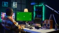 Server technician optimizing program and next to green screen