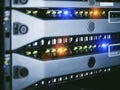 Server units in cloud service data center showing flickering light indicators for massive data connection bandwidth, close up shot