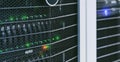 Server units in cloud service data center showing flickering light indicators for massive data connection bandwidth, close up shot