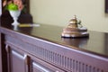 Service bell in a hotel reception for concierge alarm on desk. Royalty Free Stock Photo