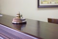 Service bell in a hotel reception for concierge alarm on desk. Royalty Free Stock Photo