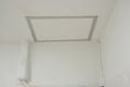 The service ceiling square shape white color with aluminium frame in building. aircondition tube connect to compressor on wall. No