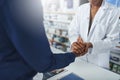 Service with compassion. a pharmacist compassionately holding a customers hand. Royalty Free Stock Photo