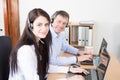 desk man woman business consultant talking on hands-free phone headset call center Royalty Free Stock Photo