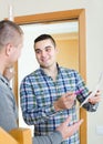 Service employee with tenant at doorway Royalty Free Stock Photo