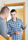 Service employee with tenant at doorway Royalty Free Stock Photo